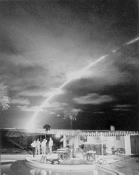 Cape Canaveral, Florida, ca. fall 1962. In contrast to the placid patio scene in the foreground, a U.S. Air Force Minuteman ICBM launched from an underground silo at  Cape Canaveral leaves a glowing trail against the 
dark Florida sky as it streaks out over the Atlantic Missile Range. 
National Archives, U.S. Air Force collection, no. 167273.
