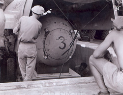 A Fat Man test unit being raised from the pit
